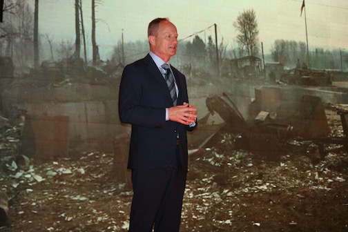 Brian Leon in front of a slide showing devastation in Fort McMurray earlier this year. Quality Inn Fort Mac was one of the first properties to reopen, and offered a safe haven for first responders.